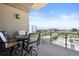 Relax on the balcony with a table, chairs, and stunning city views at 5455 Landmark Pl # 1116, Greenwood Village, CO 80111
