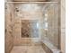 Walk-in shower featuring designer tile, a bench seat, and glass enclosure in the ensuite bathroom at 5455 Landmark Pl # 1116, Greenwood Village, CO 80111