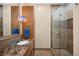 Well-lit bathroom features a marble vanity, walk-in shower, and modern fixtures at 5455 Landmark Pl # 1116, Greenwood Village, CO 80111