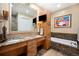 Luxurious bathroom with dual sinks, a soaking tub, and custom cabinetry at 5455 Landmark Pl # 1116, Greenwood Village, CO 80111