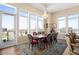 Dining area featuring a beautiful chandelier, floor to ceiling windows, and balcony access with city views at 5455 Landmark Pl # 1116, Greenwood Village, CO 80111