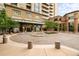Elegant building entrance featuring a circular driveway, fountain, and landscaped greenery at 5455 Landmark Pl # 1116, Greenwood Village, CO 80111