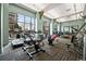 Bright fitness center with modern exercise equipment and large windows overlooking trees at 5455 Landmark Pl # 1116, Greenwood Village, CO 80111