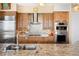 Gourmet kitchen featuring custom cabinets, granite counters, designer tile backsplash and stainless steel appliances at 5455 Landmark Pl # 1116, Greenwood Village, CO 80111