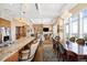 Bright, open concept living area with high ceilings, fireplace, access to the balcony, and hardwood floors at 5455 Landmark Pl # 1116, Greenwood Village, CO 80111