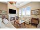 Cozy living room with a stone fireplace, plush seating, and an abundance of natural light at 5455 Landmark Pl # 1116, Greenwood Village, CO 80111