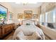 Inviting main bedroom featuring neutral decor, hardwood floors, a large window and unique art pieces at 5455 Landmark Pl # 1116, Greenwood Village, CO 80111