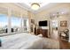 Serene main bedroom offering hardwood floors, large windows, balcony access, and ensuite bathroom at 5455 Landmark Pl # 1116, Greenwood Village, CO 80111