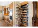 Walk-in pantry with custom shelving providing ample storage space, next to modern kitchen at 5455 Landmark Pl # 1116, Greenwood Village, CO 80111