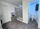 Bright bathroom with vinyl flooring, shower with glass door, and a separate toilet room at 9923 Truckee St, Commerce City, CO 80022