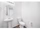 Clean half bath features a pedestal sink and white toilet at 9923 Truckee St, Commerce City, CO 80022