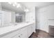 Bathroom features a double sink vanity with white countertops and modern faucets and fixtures at 9923 Truckee St, Commerce City, CO 80022