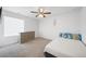 Bright bedroom featuring a large window, dresser, and a ceiling fan at 9923 Truckee St, Commerce City, CO 80022