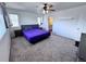 Bright bedroom with neutral carpeting, a ceiling fan, and a glimpse of the ensuite bathroom at 9923 Truckee St, Commerce City, CO 80022