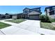 Two-story home with an attached garage, well-maintained lawn, and a concrete driveway, situated in a suburban neighborhood at 9923 Truckee St, Commerce City, CO 80022