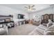 Cozy living room with neutral walls, carpet, and a ceiling fan at 9923 Truckee St, Commerce City, CO 80022