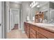 Bright bathroom featuring a double vanity with wood cabinets and modern fixtures at 11865 Barrentine Loop, Parker, CO 80138