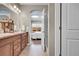 Bright bathroom with double vanity and view into the main bedroom at 11865 Barrentine Loop, Parker, CO 80138