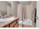 Well-maintained bathroom featuring a vanity with countertop, a toilet, and a shower/tub combo with a curtain at 11865 Barrentine Loop, Parker, CO 80138