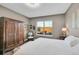 Bedroom with a hardwood floor, wooden wardrobe and a window with a view to the outside patio at 11865 Barrentine Loop, Parker, CO 80138