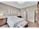 Bedroom with a hardwood floor, wooden furniture, mirrors on the wall and a window that leads to the en-suite bathroom at 11865 Barrentine Loop, Parker, CO 80138
