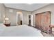 Bedroom with a hardwood floor, wooden wardrobe and a window that leads to the en-suite bathroom and kitchen at 11865 Barrentine Loop, Parker, CO 80138