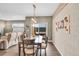 Inviting dining area featuring a stylish light fixture and access to a relaxing outdoor space at 11865 Barrentine Loop, Parker, CO 80138