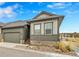 Charming home featuring stone accents, an attached garage, and tasteful landscaping, set against a blue sky at 11865 Barrentine Loop, Parker, CO 80138