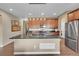 Open-concept kitchen featuring a large island, stainless appliances and modern lighting at 11865 Barrentine Loop, Parker, CO 80138
