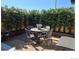 Cozy patio area features a round table with four chairs and is surrounded by lush greenery at 11865 Barrentine Loop, Parker, CO 80138