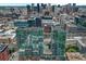 Wide aerial cityscape view of modern high-rise building with a pool deck at 1700 Bassett St # 101, Denver, CO 80202