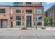 Close-up of a brick apartment building with large windows and concrete entrance at 1700 Bassett St # 101, Denver, CO 80202