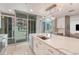 Bright, modern kitchen with stainless steel appliances, a large island, and city views from large windows at 1700 Bassett St # 101, Denver, CO 80202
