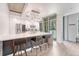Modern kitchen with marble countertops, stainless steel appliances, and a large island with bar seating at 1700 Bassett St # 101, Denver, CO 80202