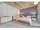Spacious primary bedroom with exposed ductwork and geometric accent wall at 1700 Bassett St # 101, Denver, CO 80202