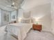 Well lit bedroom with ceiling fan and stylish wood nightstands at 1700 Bassett St # 101, Denver, CO 80202