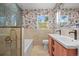 Bathroom boasts a unique floral wallpaper, double sink, and shower and tub combo at 30938 Niakwa Rd, Evergreen, CO 80439