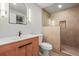 Stylish bathroom with a wood vanity, modern fixtures, decorative lighting, and a tiled shower at 30938 Niakwa Rd, Evergreen, CO 80439