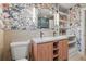 Bathroom boasts a unique floral wallpaper, double sink, and stylish mirror at 30938 Niakwa Rd, Evergreen, CO 80439