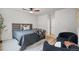 Neutral bedroom with two chairs, stylish ceiling fan, and natural light at 30938 Niakwa Rd, Evergreen, CO 80439