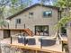 Home's exterior features a multi-tiered deck for seamless indoor/outdoor living at 30938 Niakwa Rd, Evergreen, CO 80439