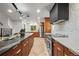 Contemporary kitchen with an island, breakfast bar, and stainless steel appliances at 30938 Niakwa Rd, Evergreen, CO 80439
