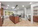 Bright kitchen with island, bar seating, and herringbone floors at 30938 Niakwa Rd, Evergreen, CO 80439