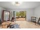 Bright living room with an open floor plan and access to an outdoor deck surrounded by natural views at 30938 Niakwa Rd, Evergreen, CO 80439