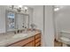 Bathroom with a granite countertop vanity, decorative mirror, and a shower featuring a white shower curtain at 4800 E Hale Pkwy # 802N, Denver, CO 80220