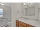 Bright bathroom featuring a granite countertop vanity, updated fixtures, and a toilet with accessibility handrail at 4800 E Hale Pkwy # 802N, Denver, CO 80220