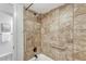 Bathroom shower with tiled surround, grab bar, and updated fixtures at 4800 E Hale Pkwy # 802N, Denver, CO 80220