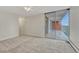 Well lit bedroom with neutral carpet and large sliding glass door providing access to an outdoor balcony at 4800 E Hale Pkwy # 802N, Denver, CO 80220