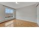 Empty bedroom with hardwood flooring, a large window offering neighborhood views, and fresh paint at 4800 E Hale Pkwy # 802N, Denver, CO 80220