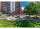 Beautifully landscaped courtyard featuring an arbor and seating, set against the backdrop of the building's facade at 4800 E Hale Pkwy # 802N, Denver, CO 80220
